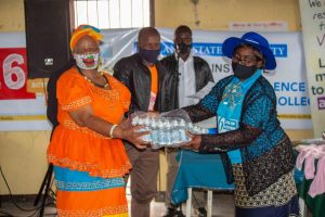 The Executive Director Prof I Muzvidziwa handed over sanitisers donated by the Gender Institute to community members who took part in the commemoration of 16 Days of activism against Gender Based Violence in Chiwundura at Muchakata business centre.
